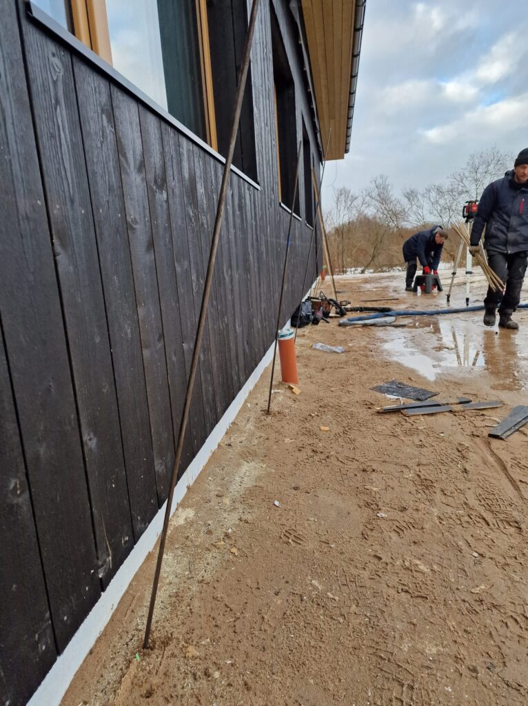 Foundation injection works in progress along building perimeter for stabilization